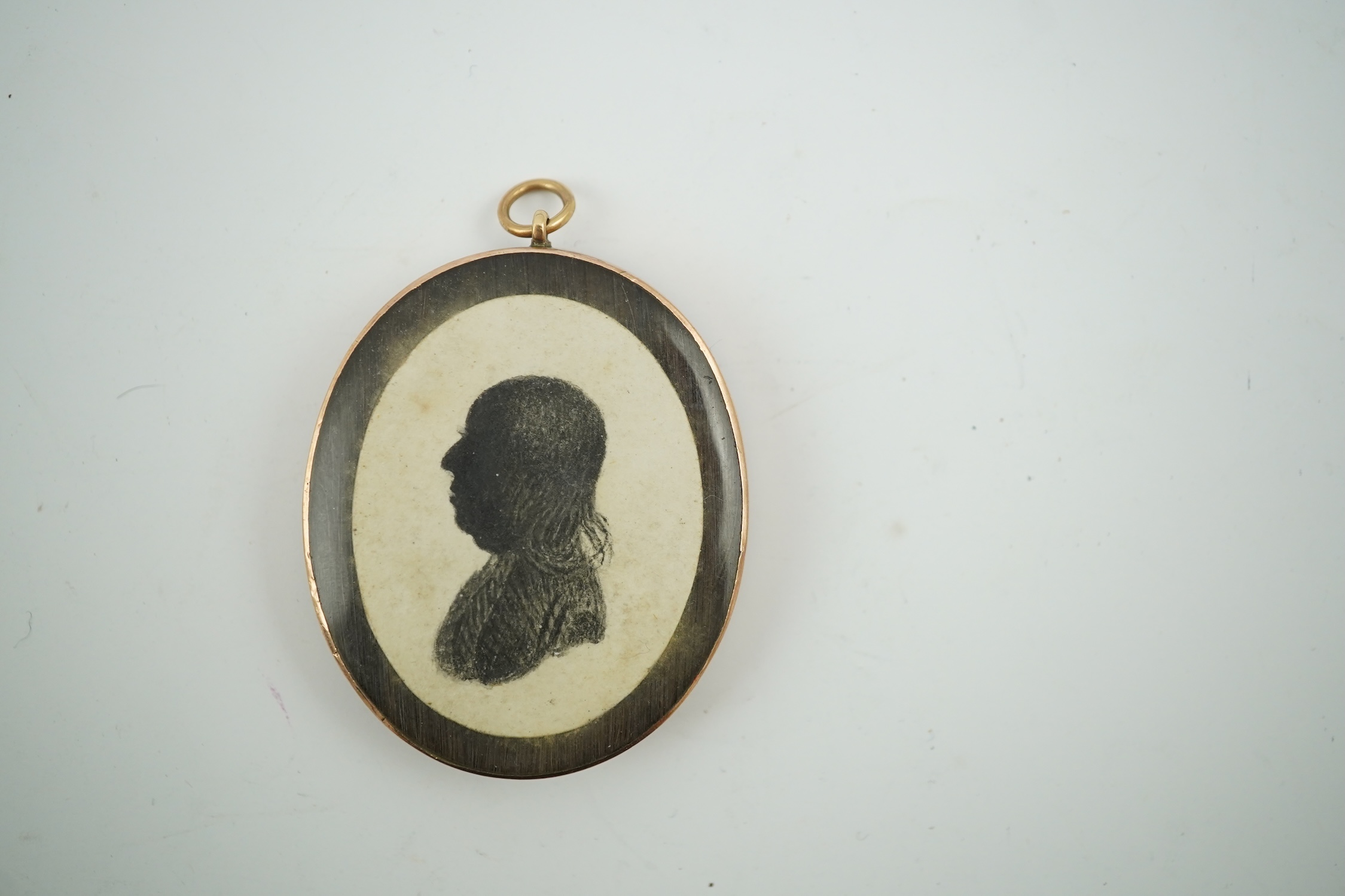 An early 19th century portrait miniature of a lady with Miers style silhouette of a gentleman verso, gold framed, 4.5cm high overall. CITES Submission reference HYCB3BFA. Condition - fair to good